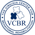The logo for the Virginia Center for Behavioral Health (VCBR) is circular. Around the circle in a band like the inscription of a ring is the name of the facility.  Inside the circle there are shapes that look like puzzle pieces, however on closer inspection the shapes each match the aerial view of the shadow prison's main building. The shape (either a building viewed from overhead or a puzzle piece) is filled in.  This offers an eerie implication that the existing facility is merely a start, and that more cages to warehouse humans after the completion of their prison sentences remain to be built. The colors are a navy blue on white background. 